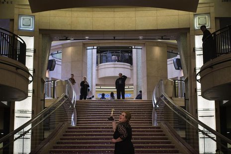 A woman poses for photos along the steps leading to the Dolby Theatre, the site for the 85th Academy Awards in Los Angeles, California Febru A woman poses for photos along the steps leading to the Dolby Theatre, the site for the 85th Academy Awards in Los Angeles, California Febru