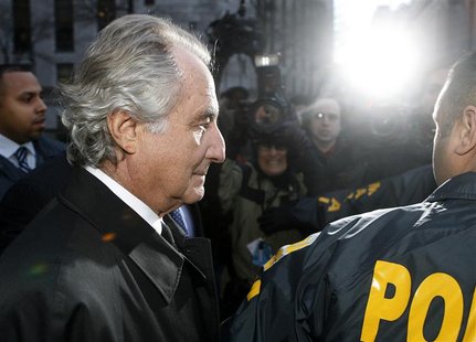 Disgraced financier Bernard Madoff is escorted by police and photographed by the media as he departs U.S. Federal Court after a hearing in N Disgraced financier Bernard Madoff is escorted by police and photographed by the media as he departs U.S. Federal Court after a hearing in N