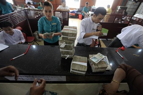 People exchange currency to Myanmar's kyat banknotes at the office of a local bank in Yangon April 2, 2012. REUTERS/Soe Zeya Tun People exchange currency to Myanmar's kyat banknotes at the office of a local bank in Yangon April 2, 2012. REUTERS/Soe Zeya Tun