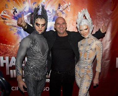 Guy Laliberte, CEO of Cirque du Soleil poses with performers as he attends the premiere of Michael Jackson THE IMMORTAL World Tour show by C Guy Laliberte, CEO of Cirque du Soleil poses with performers as he attends the premiere of Michael Jackson THE IMMORTAL World Tour show by C