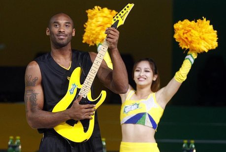NBA basketball player Kobe Bryant of the U.S. poses with an electric guitar during a charity basketball game in Shanghai August 18, 2012. RE NBA basketball player Kobe Bryant of the U.S. poses with an electric guitar during a charity basketball game in Shanghai August 18, 2012. RE