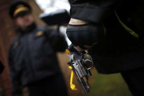An Evanston police officer holds a firearm that was turned in as part of an amnesty-based gun buyback program in Evanston, Illinois December An Evanston police officer holds a firearm that was turned in as part of an amnesty-based gun buyback program in Evanston, Illinois December