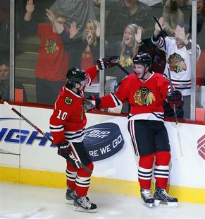 REFILE - ADDING NAME OF OPPONENT TEAM Chicago Blackhawks left wing Brandon Saad (R) celebrates his game winning goal with teammate Patrick S REFILE - ADDING NAME OF OPPONENT TEAM Chicago Blackhawks left wing Brandon Saad (R) celebrates his game winning goal with teammate Patrick S