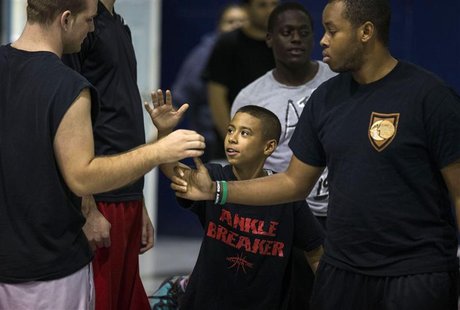 Downey Christian high school varsity basketball player 11-year-old Julian Newman (C) greets other participants during Friday evening pickup Downey Christian high school varsity basketball player 11-year-old Julian Newman (C) greets other participants during Friday evening pickup