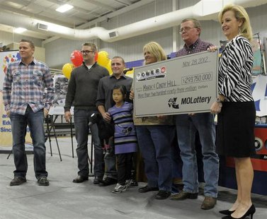 The Hill family holds an oversized check presented by Missouri Lottery director May Scheve (R) during a news conference at the North Platte The Hill family holds an oversized check presented by Missouri Lottery director May Scheve (R) during a news conference at the North Platte