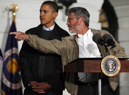 President Barack Obama (L) gets direction from White House science adviser John Holdren during an event to look at the stars with local midd President Barack Obama (L) gets direction from White House science adviser John Holdren during an event to look at the stars with local midd