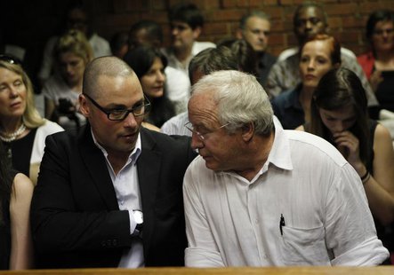 Oscar Pistorius' brother Carl and father Henke await the start of court proceedings in the Pretoria Magistrates court February 20, 2013. REU Oscar Pistorius' brother Carl and father Henke await the start of court proceedings in the Pretoria Magistrates court February 20, 2013. REU