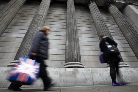 A woman carries a shopping bag decorated with a Union flag past the columns of the Bank of England in the City of London, July 3, 2012. REUT A woman carries a shopping bag decorated with a Union flag past the columns of the Bank of England in the City of London, July 3, 2012. REUT