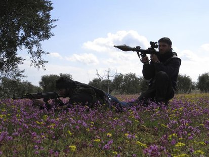 Free Syrian Army fighters hold their weapons and take positions in preparation for what they say is an ambush against forces loyal to Syria' Free Syrian Army fighters hold their weapons and take positions in preparation for what they say is an ambush against forces loyal to Syria'