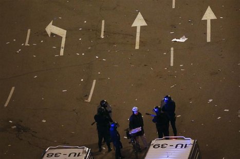 Riot policemen ask a cyclist for his identification during a protest against austerity near the Spanish Parliament, in Madrid February 23, 2 Riot policemen ask a cyclist for his identification during a protest against austerity near the Spanish Parliament, in Madrid February 23, 2