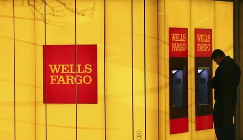 A man uses an automated teller machine (ATM) at a Wells Fargo Bank branch on a rainy morning in Washington January 17, 2012. REUTERS/Gary Ca A man uses an automated teller machine (ATM) at a Wells Fargo Bank branch on a rainy morning in Washington January 17, 2012. REUTERS/Gary Ca