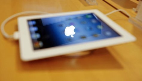An Apple logo is reflected in the screen of a new Apple iPad at an electronics store in Mumbai April 27, 2012. REUTERS/Vivek Prakash An Apple logo is reflected in the screen of a new Apple iPad at an electronics store in Mumbai April 27, 2012. REUTERS/Vivek Prakash