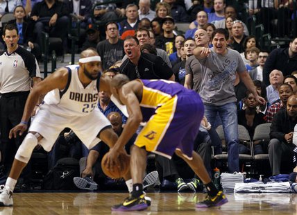Dallas Mavericks owner Mark Cuban (R) reacts as guard Vince Carter (L) guards Los Angeles Lakers guard Kobe Bryant during the second half of Dallas Mavericks owner Mark Cuban (R) reacts as guard Vince Carter (L) guards Los Angeles Lakers guard Kobe Bryant during the second half of