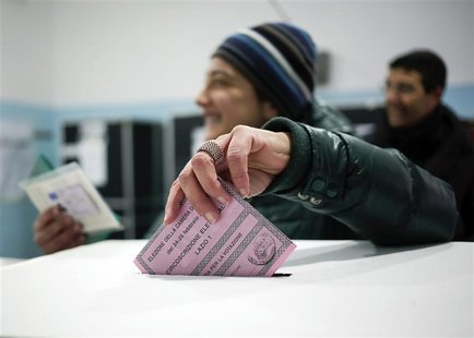 A woman casts her vote in a polling station in Rome February 24, 2013. REUTERS/Yara Nardi A woman casts her vote in a polling station in Rome February 24, 2013. REUTERS/Yara Nardi