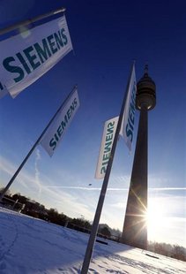 Flags of German engineering conglomerate Siemens AG flutter before the company's annual shareholder meeting in Munich January 23, 2013. REUT Flags of German engineering conglomerate Siemens AG flutter before the company's annual shareholder meeting in Munich January 23, 2013. REUT