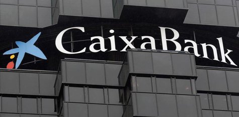 Caixabank's logo is seen on top of the company's headquarters in Barcelona, October 26, 2012. REUTERS/Albert Gea Caixabank's logo is seen on top of the company's headquarters in Barcelona, October 26, 2012. REUTERS/Albert Gea