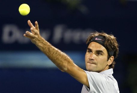 Roger Federer of Switzerland serves to Malek Jaziri of Tunisia during their men's singles match at the ATP Dubai Tennis Championships, Febru Roger Federer of Switzerland serves to Malek Jaziri of Tunisia during their men's singles match at the ATP Dubai Tennis Championships, Febru