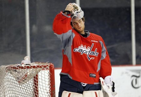 Washington Capitals goalie Braden Holtby puts on his mask as he works out at the team's facility in Arlington, Virginia January 8, 2013.REUT Washington Capitals goalie Braden Holtby puts on his mask as he works out at the team's facility in Arlington, Virginia January 8, 2013.REUT