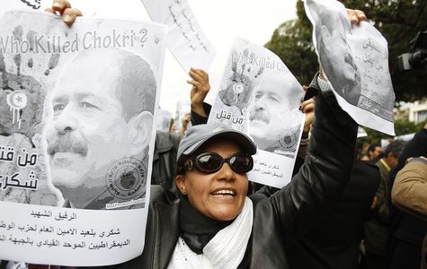 A woman chants slogans and holds pictures of assassinated leftist politician Chokri Belaid during a demonstration against the Islamist Ennah A woman chants slogans and holds pictures of assassinated leftist politician Chokri Belaid during a demonstration against the Islamist Ennah