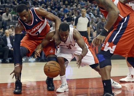 Toronto Raptors Kyle Lowry (3) is fouled by Washington Wizards John Wall (2) during the first half of their NBA basketball game in Toronto, Toronto Raptors Kyle Lowry (3) is fouled by Washington Wizards John Wall (2) during the first half of their NBA basketball game in Toronto,