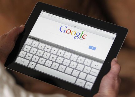 An illustration picture shows a woman holding her Apple Ipad tablet which displays a tactile keyboard under the Google home page in Bordeaux An illustration picture shows a woman holding her Apple Ipad tablet which displays a tactile keyboard under the Google home page in Bordeaux