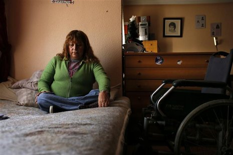 Marcheline Rosero, 45, disabled from the effects of polio as a child in Ecuador, sits on her bed in her flat in Madrid December 17, 2012. RE Marcheline Rosero, 45, disabled from the effects of polio as a child in Ecuador, sits on her bed in her flat in Madrid December 17, 2012. RE