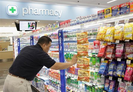 A worker stocks a new Walgreens store in Chicago January 9, 2012. Walgreen Co is going through "the worst" part of not being in Express Scri A worker stocks a new Walgreens store in Chicago January 9, 2012. Walgreen Co is going through "the worst" part of not being in Express Scri