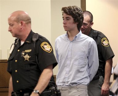 Chardon High School suspected gunman TJ Lane (C) is escorted into court for his court appearance, by Sheriffs deputies in Chardon, Ohio May Chardon High School suspected gunman TJ Lane (C) is escorted into court for his court appearance, by Sheriffs deputies in Chardon, Ohio May