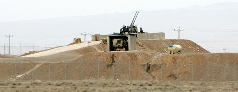 Iranian soldiers stand guard on an anti-aircraft machine gun inside the Natanz uranium enrichment facility, 322km (200 miles) south of Iran' Iranian soldiers stand guard on an anti-aircraft machine gun inside the Natanz uranium enrichment facility, 322km (200 miles) south of Iran'