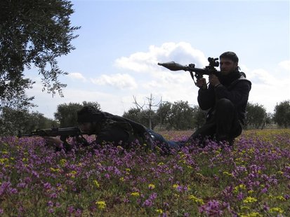 Free Syrian Army fighters hold their weapons and take positions in preparation for what they say is an ambush against forces loyal to Syria' Free Syrian Army fighters hold their weapons and take positions in preparation for what they say is an ambush against forces loyal to Syria'