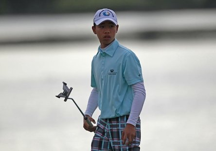 Chinese golfer Guan Tianlang, 14 year old, walks on the 11th during the second round of the Australian Open golf tournament in Sydney Decemb Chinese golfer Guan Tianlang, 14 year old, walks on the 11th during the second round of the Australian Open golf tournament in Sydney Decemb