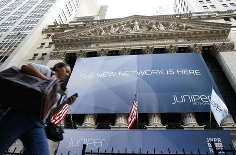 A woman walks past a banner with the logo of Juniper Networks Inc. covering the facade of the New York Stock Exchange, October 29, 2009. REU A woman walks past a banner with the logo of Juniper Networks Inc. covering the facade of the New York Stock Exchange, October 29, 2009. REU
