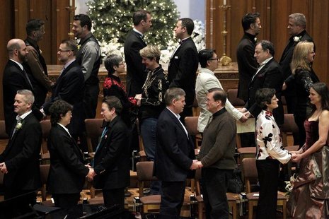 Same sex couples take their vows during a group wedding at the First Baptist Church in Seattle, Washington December 9, 2012. REUTERS/Jordan Same sex couples take their vows during a group wedding at the First Baptist Church in Seattle, Washington December 9, 2012. REUTERS/Jordan