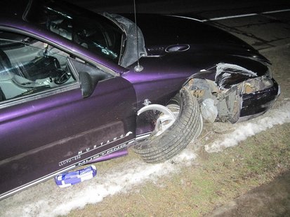 Car snapped a utility pole before coming to rest about 50 feet further down the road. Car snapped a utility pole before coming to rest about 50 feet further down the road.