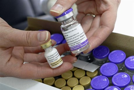 A nurse holds a bottle of the Pandemrix H1N1 flu vaccine (R) and a bottle of the vaccine's adjuvant (L) at a health centre in Burgos in this A nurse holds a bottle of the Pandemrix H1N1 flu vaccine (R) and a bottle of the vaccine's adjuvant (L) at a health centre in Burgos in this