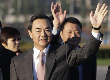 Wang Yi, the director of China's National Taiwan Affairs Office, waves to see Chen Yunlin (not in picture), chairman of China's Association Wang Yi, the director of China's National Taiwan Affairs Office, waves to see Chen Yunlin (not in picture), chairman of China's Association