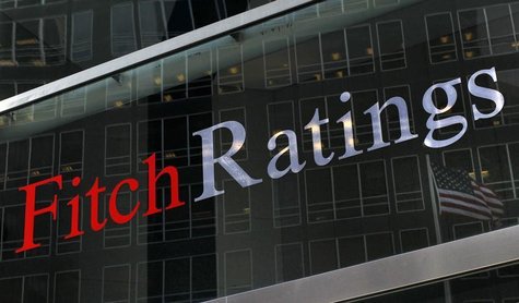 A flag is reflected on the window of the Fitch Ratings headquarters in New York February 6, 2013. REUTERS/Brendan McDermid A flag is reflected on the window of the Fitch Ratings headquarters in New York February 6, 2013. REUTERS/Brendan McDermid