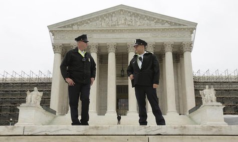 Two policemen talk in front of the U.S. Supreme Court in Washington June 18, 2012. REUTERS/Kevin Lamarque Two policemen talk in front of the U.S. Supreme Court in Washington June 18, 2012. REUTERS/Kevin Lamarque