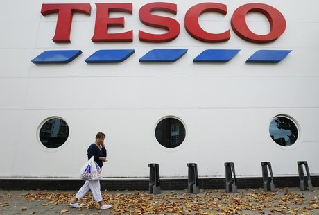 A shopper passes a Tesco supermarket in London October 5, 2011. REUTERS/Luke MacGregor A shopper passes a Tesco supermarket in London October 5, 2011. REUTERS/Luke MacGregor