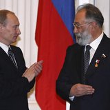 Russia's President Vladimir Putin (L) applauds after he decorated Russian State Duma member Artur Chilingarov, the leader of the 2007 Arctic Russia's President Vladimir Putin (L) applauds after he decorated Russian State Duma member Artur Chilingarov, the leader of the 2007 Arctic