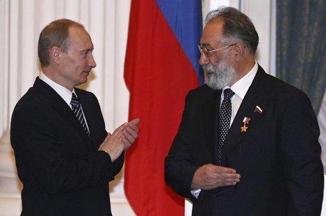Russia's President Vladimir Putin (L) applauds after he decorated Russian State Duma member Artur Chilingarov, the leader of the 2007 Arctic Russia's President Vladimir Putin (L) applauds after he decorated Russian State Duma member Artur Chilingarov, the leader of the 2007 Arctic