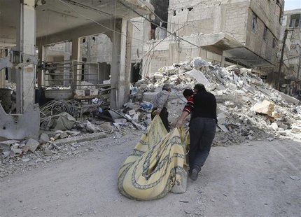 Three men remove debris from a building damaged by forces loyal to Syrian President Bashar al Assad at the Harasta area in Damascus February Three men remove debris from a building damaged by forces loyal to Syrian President Bashar al Assad at the Harasta area in Damascus February
