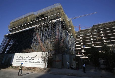 A worker walks in front of the under-construction One BKC commercial complex, being built by The Wadhwa Group, in the Bandra-Kurla Complex i A worker walks in front of the under-construction One BKC commercial complex, being built by The Wadhwa Group, in the Bandra-Kurla Complex i