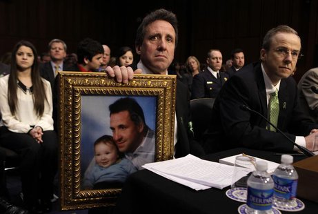 Neil Heslin, holds a picture of himself and his 6-year-old son, Newtown victim Jesse Lewis, during the Senate Judiciary Committee hearing on Neil Heslin, holds a picture of himself and his 6-year-old son, Newtown victim Jesse Lewis, during the Senate Judiciary Committee hearing on