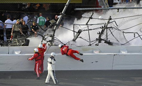 Rescue workers respond next to a hole in the catch fence following a last-lap incident during the NASCAR Nationwide Series DRIVE4COPD 300 ra Rescue workers respond next to a hole in the catch fence following a last-lap incident during the NASCAR Nationwide Series DRIVE4COPD 300 ra