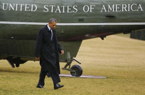 U.S. President Barack Obama walks on the South Lawn after stepping off Marine One in the rain after returning to the White House in Washingt U.S. President Barack Obama walks on the South Lawn after stepping off Marine One in the rain after returning to the White House in Washingt