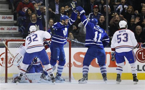 Toronto Maple Leafs' Frazer McLaren (2nd L) celebrates his goal with teammate Jay McClement (2nd R) in front of Montreal Canadiens' Travis M Toronto Maple Leafs' Frazer McLaren (2nd L) celebrates his goal with teammate Jay McClement (2nd R) in front of Montreal Canadiens' Travis M