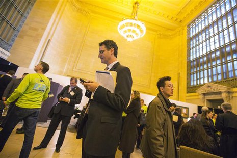 A job seeker looks at his mobile phone as he waits to speak with recruiters during a job fair put on by online recruiting company The Ladder A job seeker looks at his mobile phone as he waits to speak with recruiters during a job fair put on by online recruiting company The Ladder