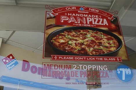 A poster for Domino's Hand Made Pan Pizza is displayed in a window of a Domino's pizza restaurant in Burbank, California October 16, 2012. R A poster for Domino's Hand Made Pan Pizza is displayed in a window of a Domino's pizza restaurant in Burbank, California October 16, 2012. R