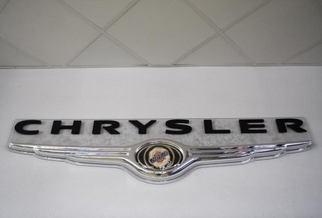 The Chrysler logo hangs on the wall at Performance Chrysler Jeep Dodge 